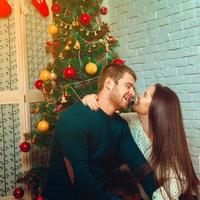 square portrait of beautiful couple near christmas tree photo