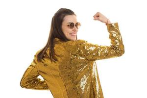 Happy elegant woman in golden jacket smiles on camera photo