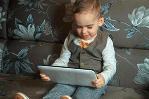 little boy in suit with tablet photo