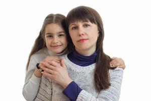 portrait of lovely mother with daughter hugs on camera photo