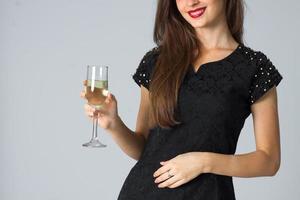 girl in black dress posing in studio photo