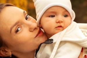 beautiful young mom with baby in autumn photo