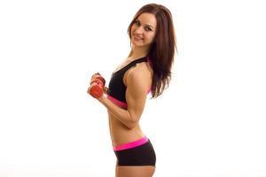 lovely young sports girl posing with dumbbells photo