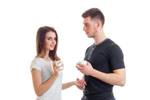 smiling beautiful girl with nice guy talks and they are holding Cup photo