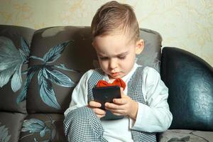 niño pequeño con teléfono móvil foto