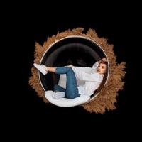 glamour woman sits in circle chair with deadwood around photo