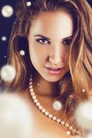 Close up portrait of lovely female with lots of pearls photo