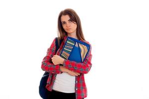 brooding teenage girl in Plaid Shirt looks to the side and holding a folder photo