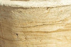Ancient Greek characters carved in stone photo