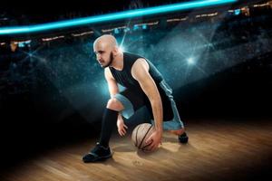 man in basketball action game dribbles photo