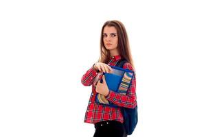 portrait of young serious student girl with backpack and folders for notebooks isolated on white background photo