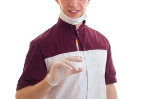doctor in uniform holding the syringe in hands photo