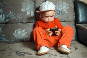 young boy in red suit and cap photo