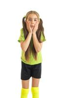 Vertical portrait of funny little girl in soccer uniform photo