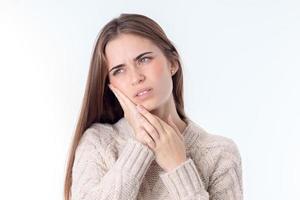 young girl with dental pain that keeps Palm person isolated on white background photo