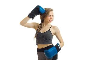 beautiful young blonde with a pigtail looks away in boxing gloves smiling photo