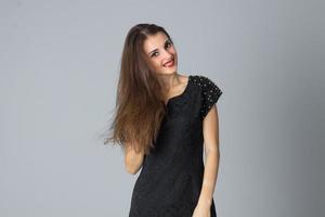 girl in black dress posing in studio photo