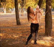 Cute young mother with her little baby girl photo