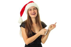 portrait of cheerful lovely girl in santa hat photo