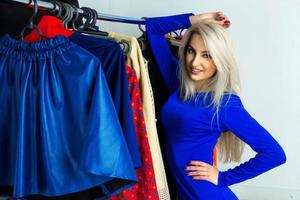 Cutie young blonde gitl in clothing store photo