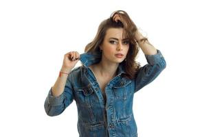 beautiful young brunette in jeans jacket posing for the camera photo