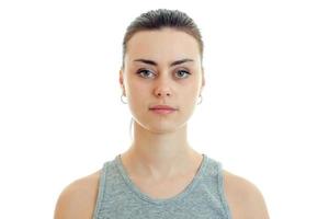 Portrait of beautiful serious girl who stands up straight and looking at camera photo