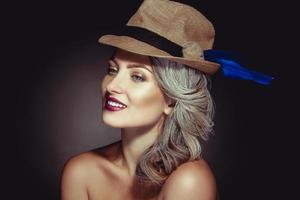 Cutie girl with beautiful makeup and stylish hat smiling photo