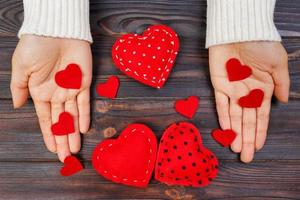 A woman holds a red heart in her hands. Love concept photo