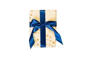 Christmas or other holiday handmade present in gold paper with blue ribbon. Isolated on white background, top view. thanksgiving Gift box concept photo