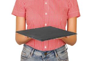 woman dressed in shirt holding a square slate platter or a board in front of her. perspective view Template for your design. isolated on white background photo