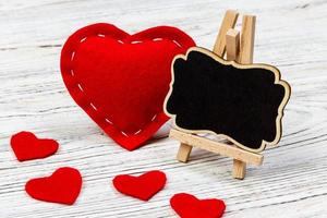 A red heart with black board and small hearts. copy space photo