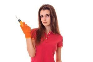 young brunette woman builder makes renovation with screwdriver in her hands isolated on white background photo