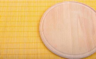 Empty round wooden board with tablecloth. photo