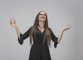 bella mujer celebrando el año nuevo con confeti y champán foto