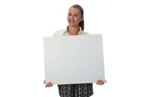 Happy young businesswoman doing business presentation at whiteboard, smiling, isolated on white background. photo