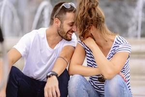 Couple of tourists having fun walking on city street at holiday - Happy friends laughing together on vacation - People and holidays concept photo