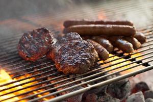 Delicious Australia Day BBQ. Beef burger and Sausages, Australian style barbecue on the grill, looking scrumptious. Close up photo