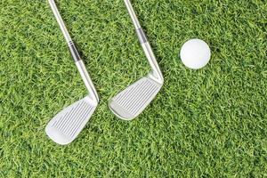 Golf club and Golf ball on green grass photo