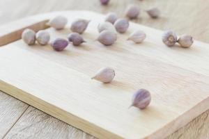 Garlic on wood cutting board photo