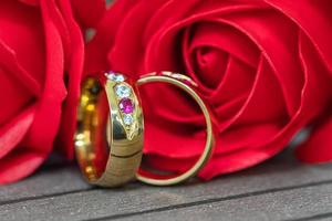 Close up wedding ring and red rose photo