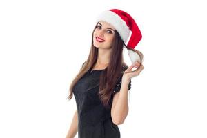 young brunette girl in santa hat photo