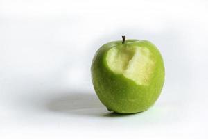 Fresh green apples and bite marks on a white background. photo