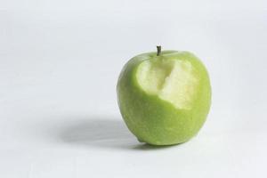 Fresh green apples and bite marks on a white background. photo