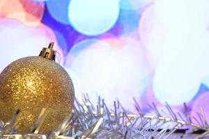 Christmas toy. Christmas decoration, gold ball Christmas decorations with tinsel on a light background. Conception Christmas and New Year.