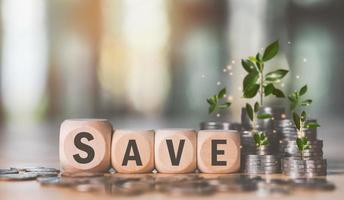 Wooden blocks and pile of coins, finance and banking, fund growth and savings concept, saving money for future, financial efficiency planning, retirement savings, financial freedom photo