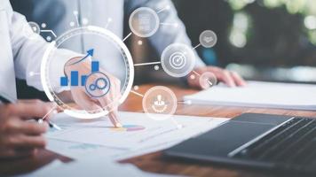 Analysts monitor business growth performance ,From the annual report,To analyze the achievement of marketing strategy,Improvement and development from indicators to develop towards goals photo