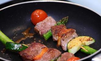Meat and vegetables roasted skewers photo