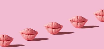 Banner with pink lips on pink background. Creative background photo
