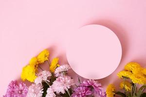 Podium or pedestal with chrysanthemum flowers top view. Mockup for your cosmetic products photo