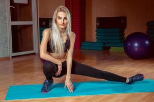 blonde girl is doing exercises photo